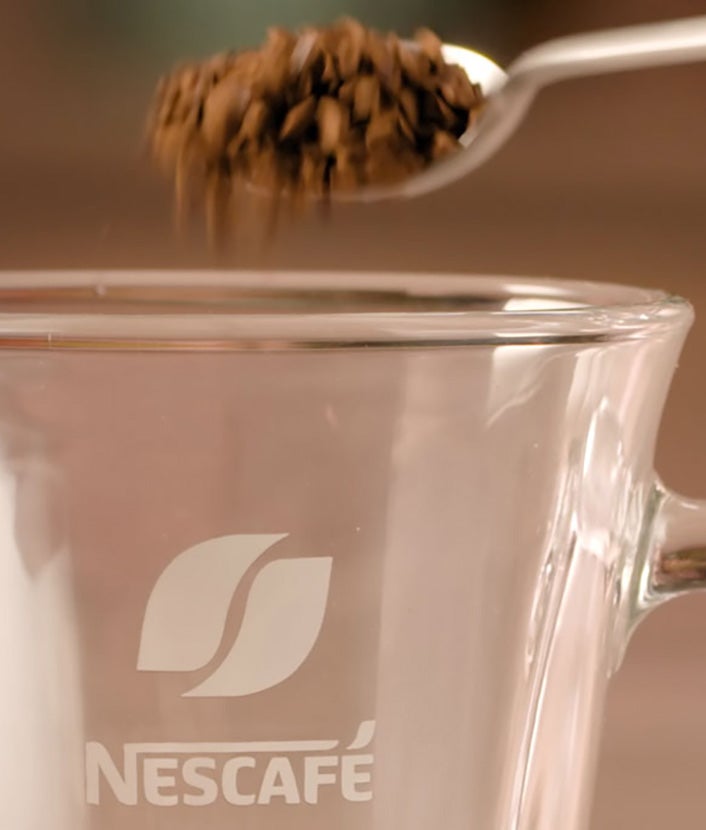 Mix Nescafé Gold with hot water