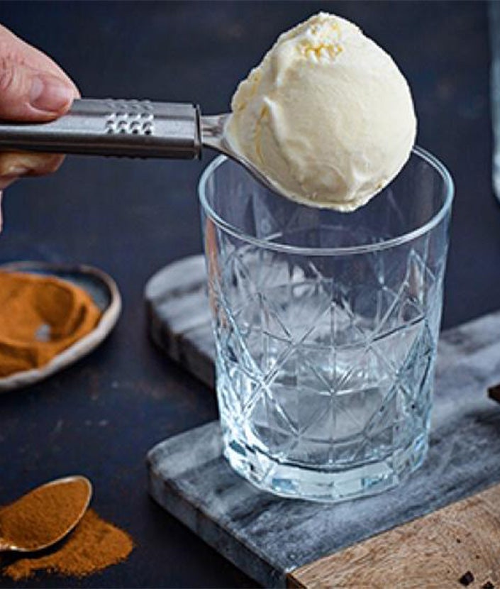 hands scooping ice cream into cup