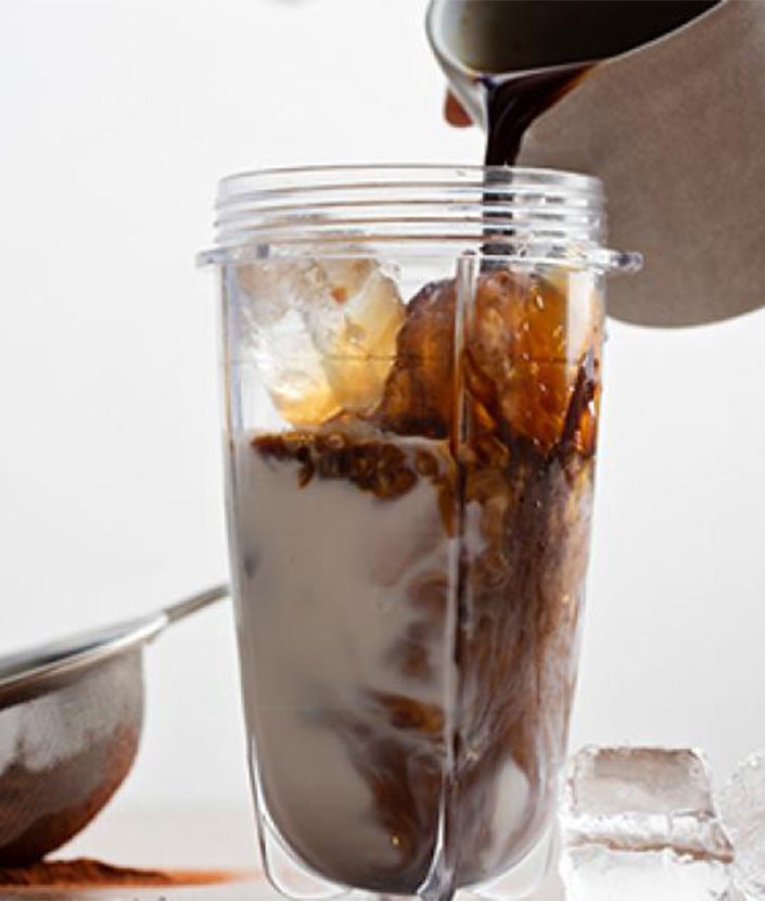 pouring black coffee into iced blender