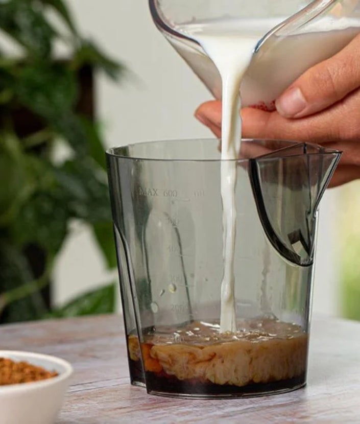 pouring milk into jug with coffee