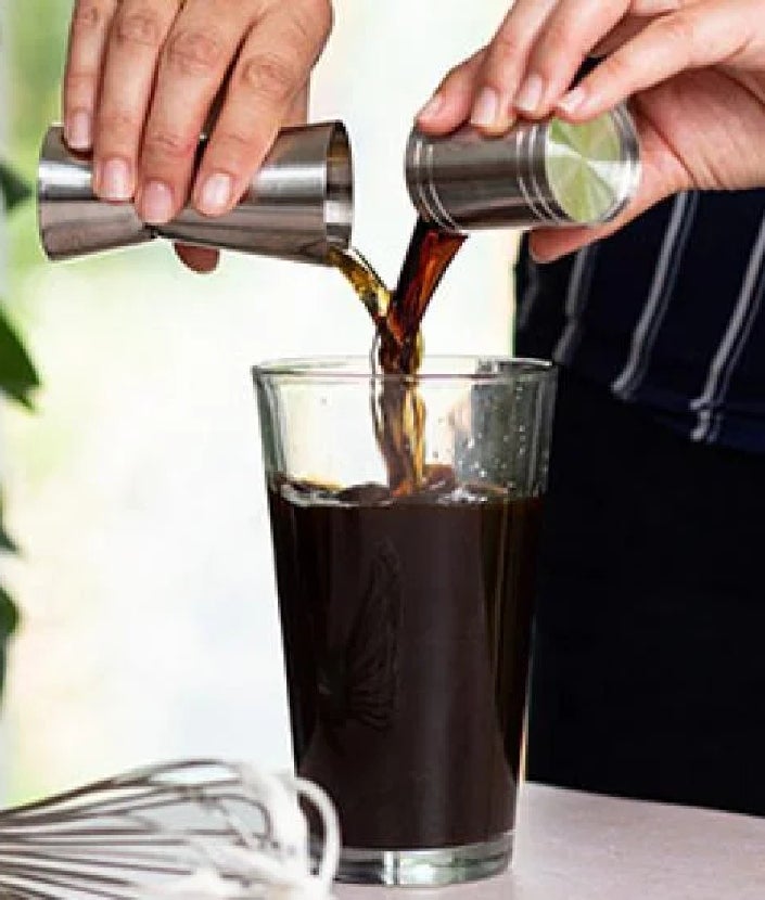 mixing syrup and espresso into cup