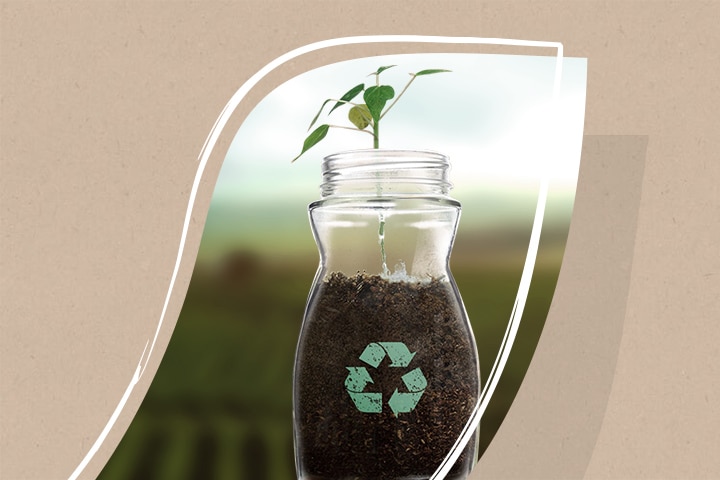 Glass jar with a recycling icon with coffee in it.