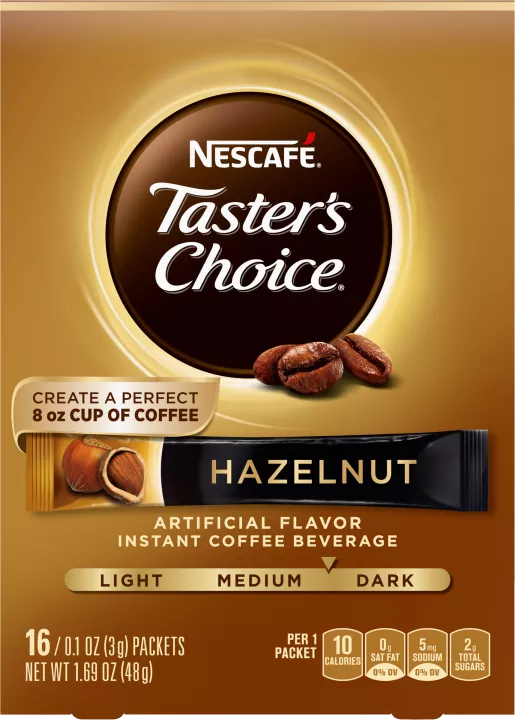 A gold box of Taster’s Choice Hazelnut instant packets coffee beans near the Taster's Choice logo.
