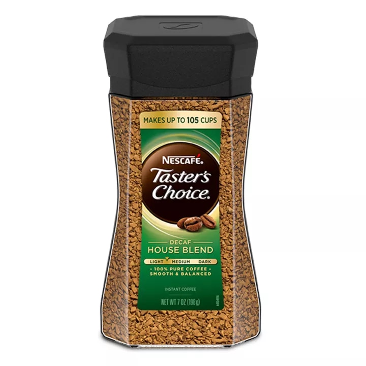 A jar of decaf Taster’s Choice House Blend instant coffee with a black lid and green label.